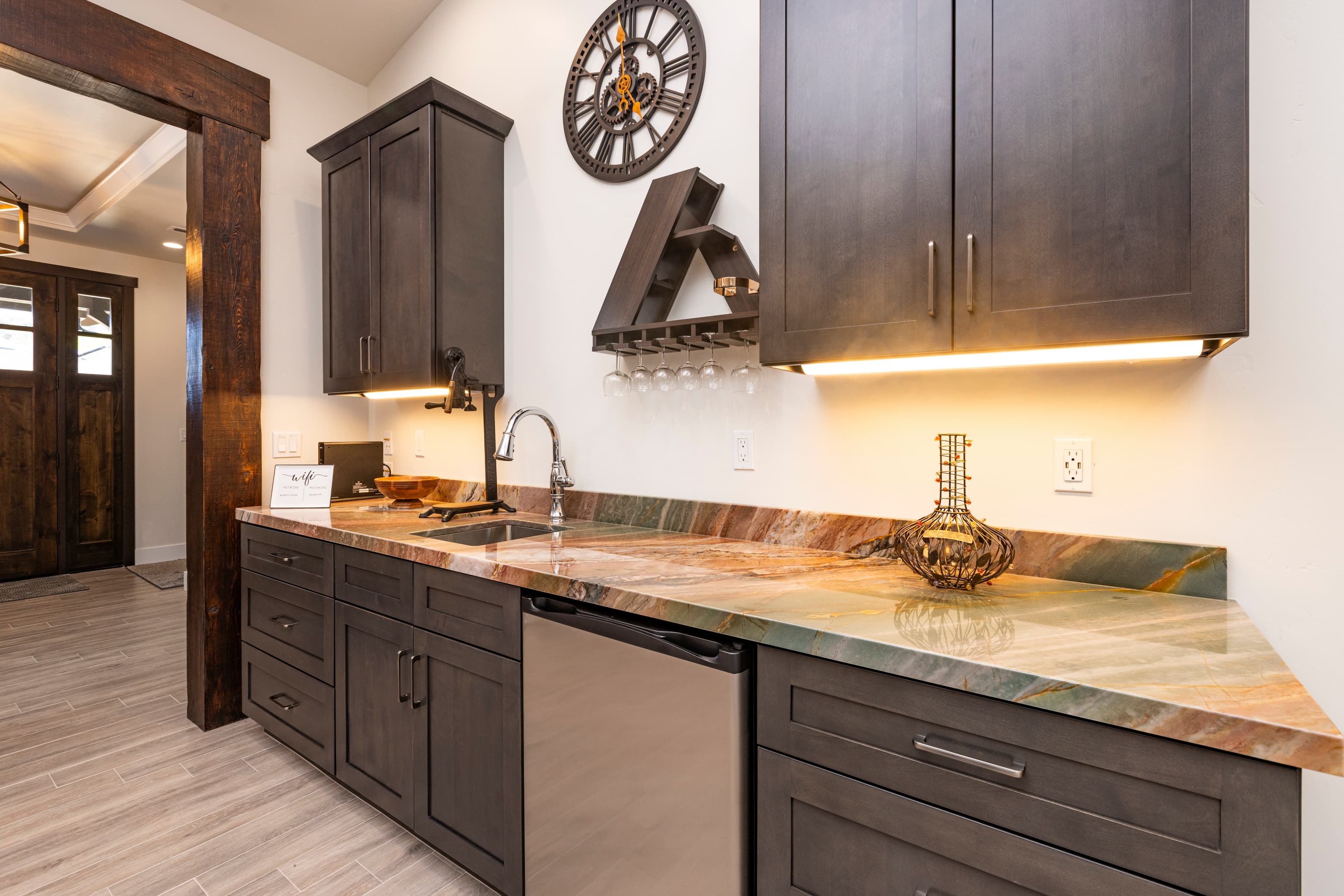 A modern kitchen interior featuring dark cabinets and a colorful countertop.